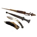 A kukri with original sheath, together with two north African daggers (3)