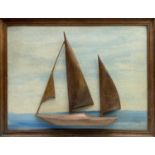 20th Century Cornish SchoolA polished elm relief sculpture of a yacht, mounted on a sea-painted