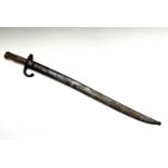 A French 1874 pattern bayonet, with brass grip, the blade inscribed St Etienne and contained in a