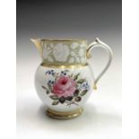 A good moulded and well painted jug, circa 1830, with armorial device, gilding, and flowers in