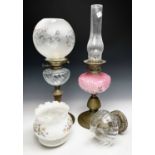Three oil lamps with glass reservoirs, two with glass shades (3)