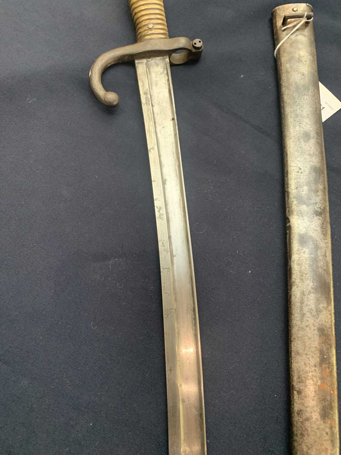 A French 1874 pattern bayonet, with brass grip, the blade inscribed St Etienne and contained in a - Image 3 of 5