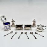 A collection of silver condiments and six silver salt spoons