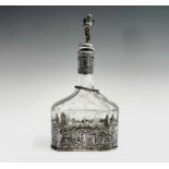 A Dutch glass decanter with cast silver base and neck, the stopper silver-mounted with a cherub