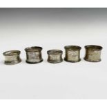 A pair of silver napkin rings (case dilapidated) and three other silver napkin rings 3.2oz of