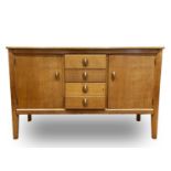 A Gordon Russell Limited oak sideboard, with four central drawers flanked by two cupboard doors,