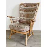 A modern Ercol beech framed upholstered armchair.Condition report: Areas of rubbing and wear to