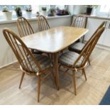 An Ercol pale elm dining table with set of six quaker chairs, length of table 152cm.Condition