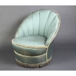 A 1950's cloud back tub back armchair, upholstered in blue material