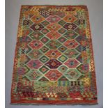 A yellow, turquoise and green ground Chobi Kilim rug with all over geometric design 182cm x 121cm