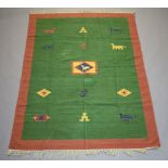 A green and tan ground Kilim rug with stylised decoration 203cm x 150cm