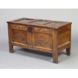 A 17th/18th Century carved oak coffer of panelled construction with original hinges 57cm h x 105cm w