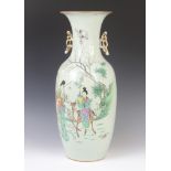 An 18th Century style Chinese famille rose vase with pierced gilt handles, decorated a lady riding a