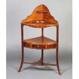 A Georgian mahogany corner wash stand with raised back fitted 2 bowl recepticals, the undertier