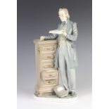A Lladro figure of a gentleman standing beside a 5 drawer chest 34cm