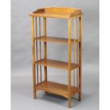 An oak Art Nouveau style 4 tier bookcase with 3/4 gallery, raised on square supports 128cm h x