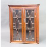 A 19th Century mahogany hanging corner cabinet with moulded cornice enclosed by by astragal glazed