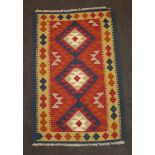 A red, tan and black ground Maimana Kilim with 3 stylised diamonds to the centre 131cm x 84cm