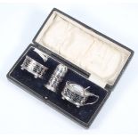 A silver 3 piece condiment set with pierced decoration Birmingham 1919, 66 grams