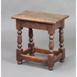 A Victorian 17th Century style oak joined stool with carved apron, raised on turned and block