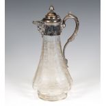 An Edwardian cut glass claret jug with plated mounts having a mask spout and scroll handle 31cm