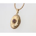 A 9ct yellow gold gem set locket and necklace 7.7 grams