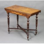 A Victorian rectangular inlaid rosewood card table, raised on turned supports with X framed