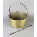 A polished brass preserving with polished steel handle 15cm x 33cm together with an iron blacksmiths