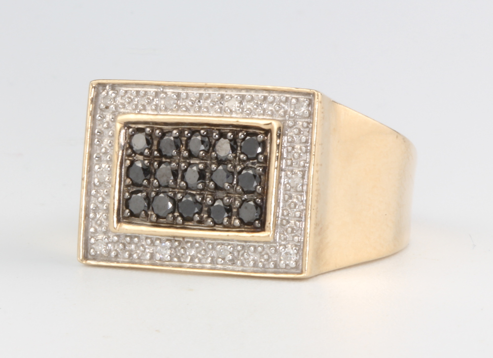 A gentleman's 9ct yellow gold white and black diamond rectangular ring, 4.5 grams, size V