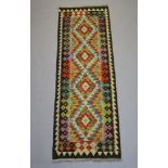 A yellow, brown and turquoise patterned Chobi Kilim runner with 4 stylised diamonds to the centre