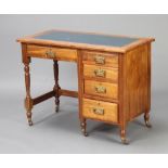 An Edwardian Art Nouveau oak typists desk with green leather writing surface, fitted 1 long and 4