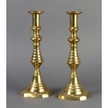 A pair of Victorian brass candlesticks with ejectors 27cm h x 10cm w x 10cm d