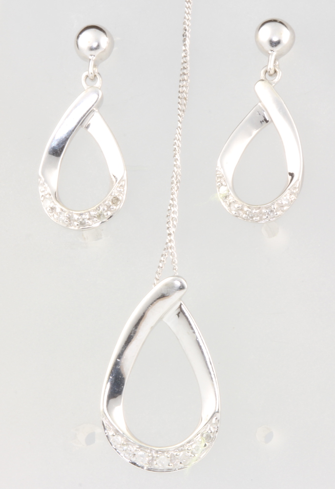 A 9ct white gold diamond drop pendant and ditto earrings, 3.8 grams