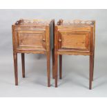 A pair of Georgian style mahogany night tables with pierced gallery enclosed by panelled doors,