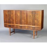A mid-Century rosewood sideboard, the interior fitted shelves and 2 short drawers enclosed by