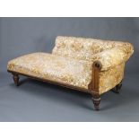 A Victorian oak show frame chaise longue, the raised back upholstered in buttoned material, raised