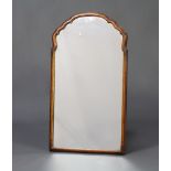 A 1930's Queen Anne style arched plate mirror contained in a walnut frame 68cm x 38cm