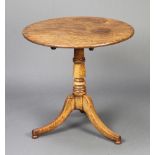 A Georgian circular oak snap top tea table, raised on turned column and tripod base, bun feet,