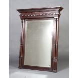 A 19th Century French rectangular bevelled plate over mantel mirror contained in a carved walnut
