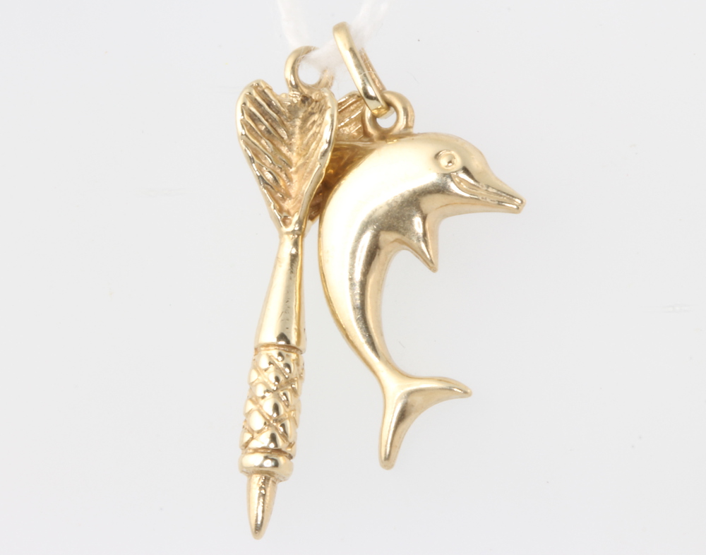 Two 9ct yellow gold charms of a dolphin and a dart, 1.7 grams