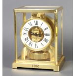 Jaeger LeCoultre, an Atmos clock with white dial and Roman numerals contained in a gilt metal