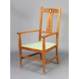 An Edwardian Art Nouveau Liberty style inlaid oak slat back carver chair with upholstered seat,