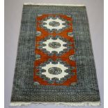 A brown, white and grey ground Bokhara rug with 3 stylised octagons to the centre within a multi row