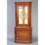 A 19th Century mahogany double corner cabinet, the upper section with moulded cornice fitted a