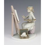 A Lladro figure of a seated girl artist before an easel 5363 17cm Paint brush is missing