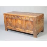 A 17th/18th Century carved oak coffer of panelled construction with hinged lid, possible replacement