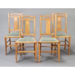 A set of 4 Art Nouveau Liberty style inlaid oak slat back bedroom chairs, raised on square tapered