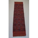 A red and green ground Meshwani runner with 5 octagons to the centre 240cm x 58cm