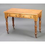An Arts and Crafts rectangular painted pine side table fitted 2 drawers, the apron with painted