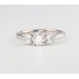 An 18ct white gold 3 stone diamond ring, approx. 0.98ct, size M, 3.4 grams